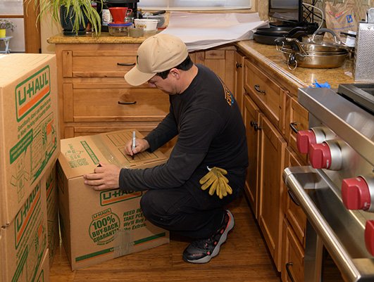 worker labels the boxes