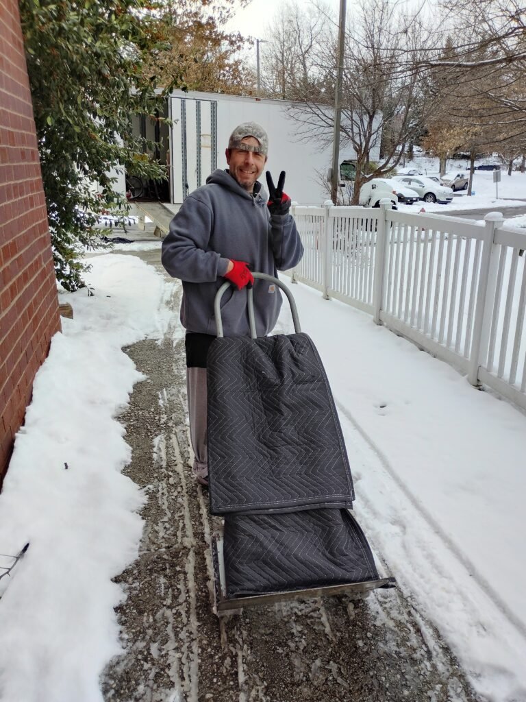 picture of a worker hauling boxes